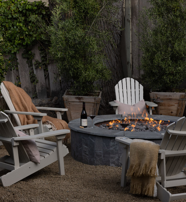 firepit surrounded by adirondack chairs